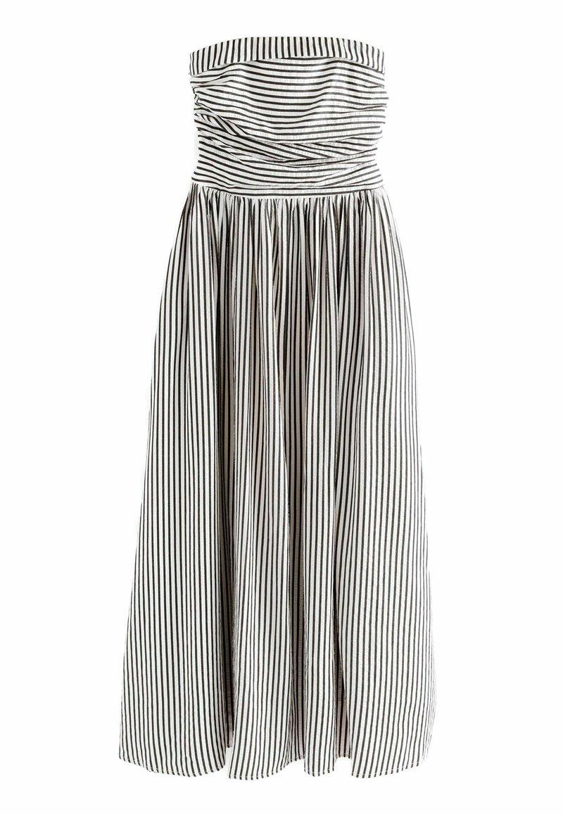 Brezramni črno-beli črtasti outfit, nabran zgornji del, krilo do kolen z gubami, lahko tkanino, gladka tekstura.