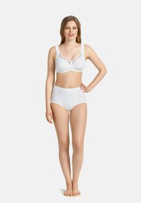 Witte beha met doorschijnende mesh accenten en brede banden, gecombineerd met hoge witte slipjes. Het materiaal lijkt glad en rekbaar.