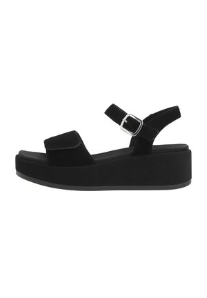 Sandalias de plataforma de ante negro con una correa superior ancha, correa ajustable en el tobillo y hebilla plateada. Suela gruesa y texturizada para mayor altura.
