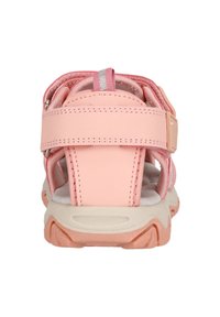 Pink sandals with adjustable straps, textured material, cushioned interior, and a rubber outsole with a patterned grip.