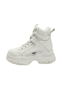 White high-top sneaker with a thick rubber sole, textured canvas upper, padded collar, and metal eyelets for laces. Logo on the side.