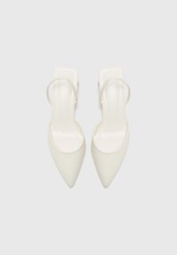 White pointed-toe slingback heels with a smooth finish, featuring a subtle ankle strap and a sleek square heel design.