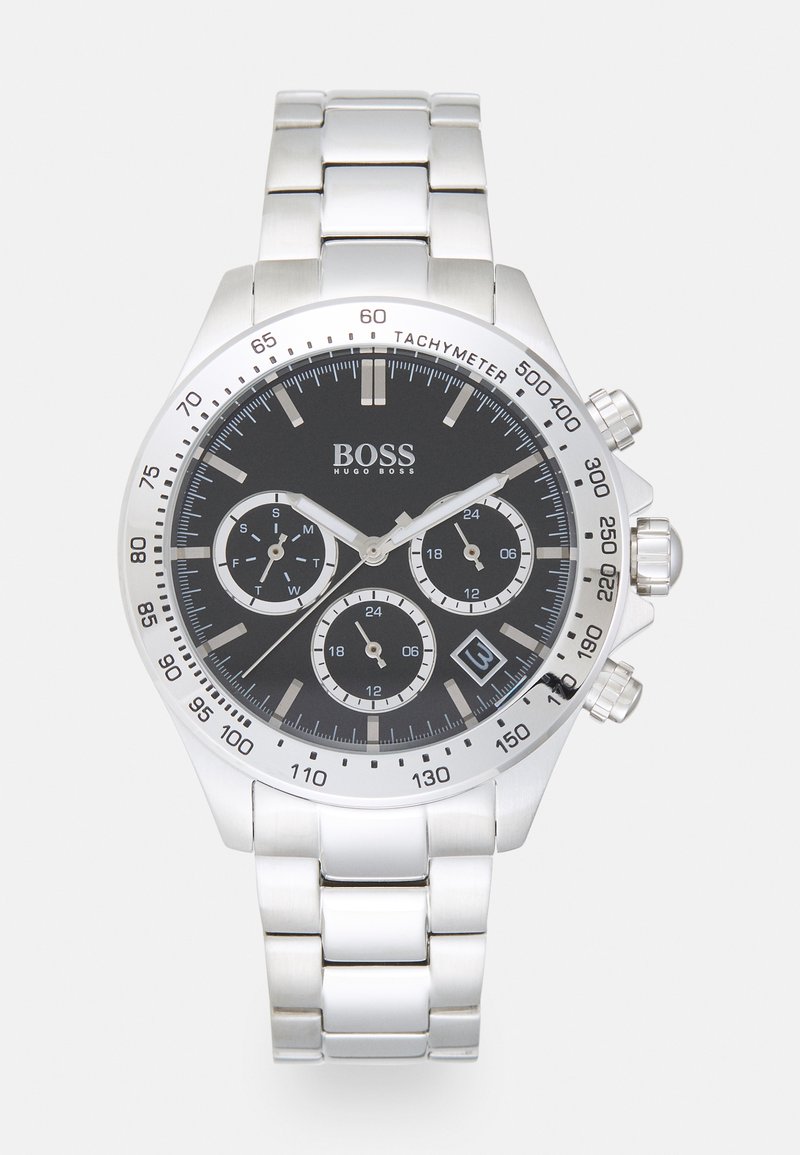 Silver metal watch with a black dial, chronograph functions, date display, tachymeter scale, and a stainless steel bracelet.