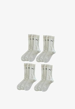 Weiße Baumwoll-Sportsocken mit ribbed Design und schwarzen Logo-Akzenten. Set enthält sechs Paare. Glatte Textur, mittellange Länge.