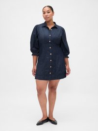 Abito di jeans con chiusura frontale a bottoni, maniche a sbuffo, corsetto aderente e gonna svasata. Tessuto blu scuro con finitura testurizzata.