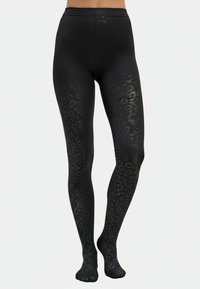 Leggings negros con un acabado mate que presentan un sutil patrón de animal print. Diseño de cintura alta, material elástico y estilo con pies.