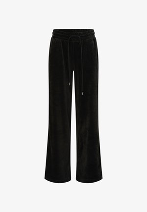 Schwarze weite Hosen aus weichem Samt. Mit einem elastischen Bund und einer Kordel zum Verstellen, ohne sichtbare Taschen oder Muster.