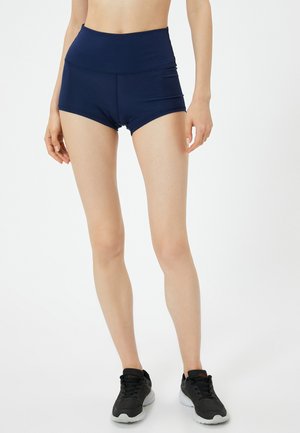 Pantalones cortos deportivos de talle alto en azul marino, hechos de una tela elástica, con una textura suave y detalles de costura mínimos.