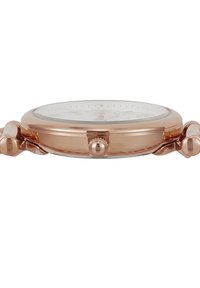 Montre-bracelet en or rose avec un boîtier rond et fin, un verre en face, et une couronne sur le côté. Dispose d'un cadran simple avec des marqueurs horaires.