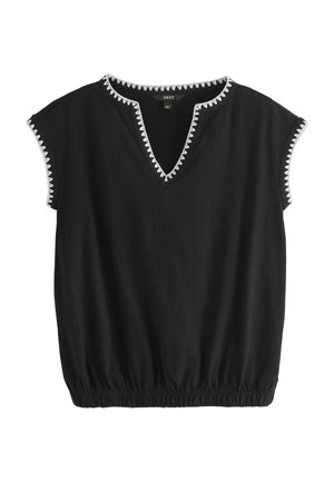 Black short-sleeve blouse with white zigzag trim on neckline and sleeve edges, elasticized hem for a gathered fit.