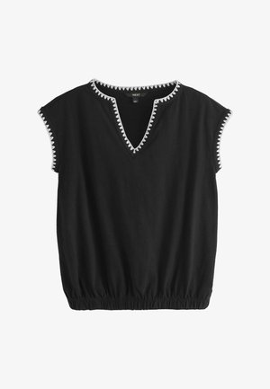 Black short-sleeve blouse with white zigzag trim on neckline and sleeve edges, elasticized hem for a gathered fit.
