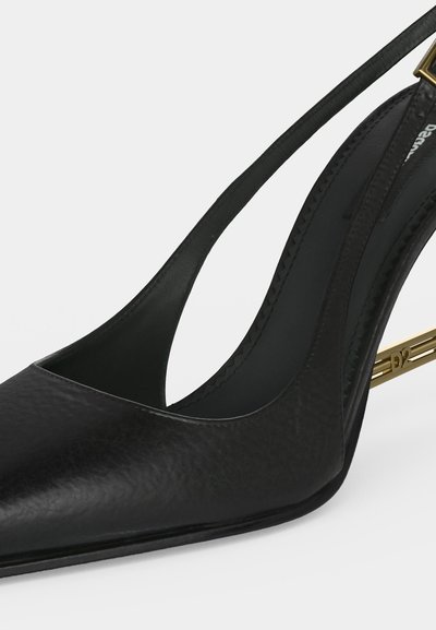 Black leather pointed-toe slingback shoe with a gold metal stiletto heel engraved with "D2" on a white background.