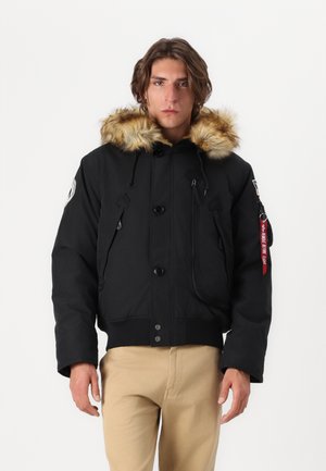 Black winter jacket with a faux fur-lined hood, feature buttons and zipper closures, two front pockets, and a red keychain accent.