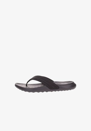 Chancla negra con plantilla texturizada, tira redonda y amplia de tela con costuras decorativas. Suela ligera y flexible.