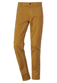 Musztardowe bawełniane chinosy w slim fit, z przednimi kieszeniami i pojedynczym zapięciem na guzik. Gładka tekstura z minimalnymi detalami szwów.