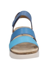 Multi-tone blue leather sandal with three straps and a textured footbed. Features a light-colored sole with a cork detail.