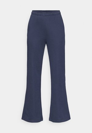 Tumesinised laiade pükstega püksid, mis on valmistatud pehmest kangast, varustatud elastse vöökohaga ja siledapinnalise tekstuuriga ning korrektselt lõpetatud äärega.