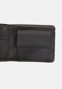 Black leather wallet interior with card slots and a rectangular pocket. Smooth texture and precise stitching details.