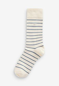 Chaussette de couleur crème avec des rayures bleu marine, dotée d'un bord côtelé et d'une texture lisse. Comprend un petit logo près de la cheville.