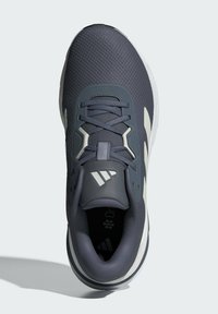 Sport sneakers in dark gray mesh with light gray accents. Features a lace-up design, padded collar, and textured surface for grip.