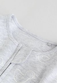 Gray cotton onesie featuring white duck patterns, round neckline with a snap closure, and a soft texture. Brand label visible inside.