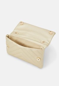 Guldig satinclutch med chevronmönster, utrustad med fodrad insida och två metalliska knappstängningar. Öppen för att visa det inre facket.