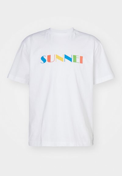 White cotton t-shirt with short sleeves featuring multicolored block letters spelling "SUNNEI" across the chest. Simple design and cut.