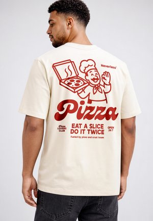 Man wearing cream t-shirt with red graphic of smiling chef holding pizza box and text about pizza on the back.
