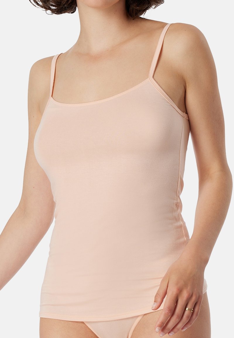 Light pink camisole top with thin straps, smooth fabric, fitted design, and a straight hemline, ideal for layering or casual wear.