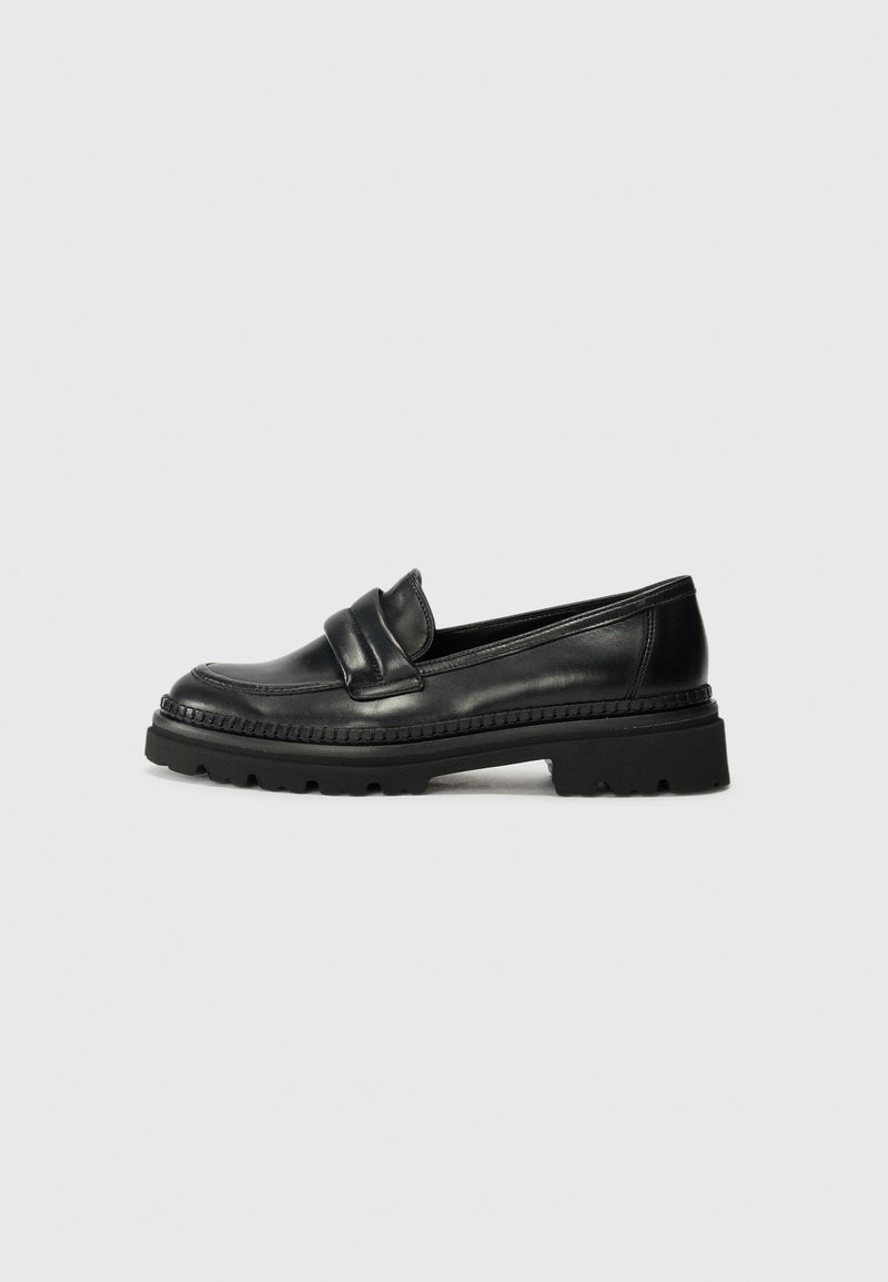 Black leather loafers with a rounded toe, double strap detail, and a thick, textured sole. Features a stitched border for added detail.