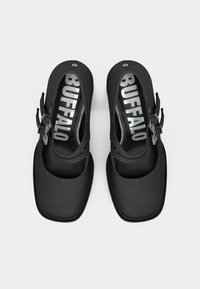 Černé boty s hladkým matným povrchem. Mají otevřenou špičku, čtvercový tvar, nastavitelný pásek a bíle vyražený nápis "BUFFALO".