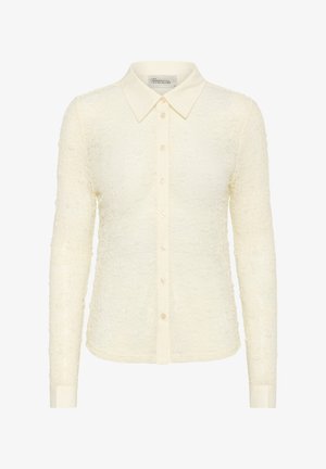 Cream long-sleeved shirt with a textured, floral pattern, full front button closure, and a classic collar. Soft fabric and fitted design.