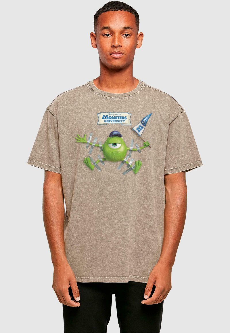 Beige übergroßes T-Shirt aus Baumwolle, mit einem Grafikdesign eines grünen Charakters aus Monsters University und Textdetails.