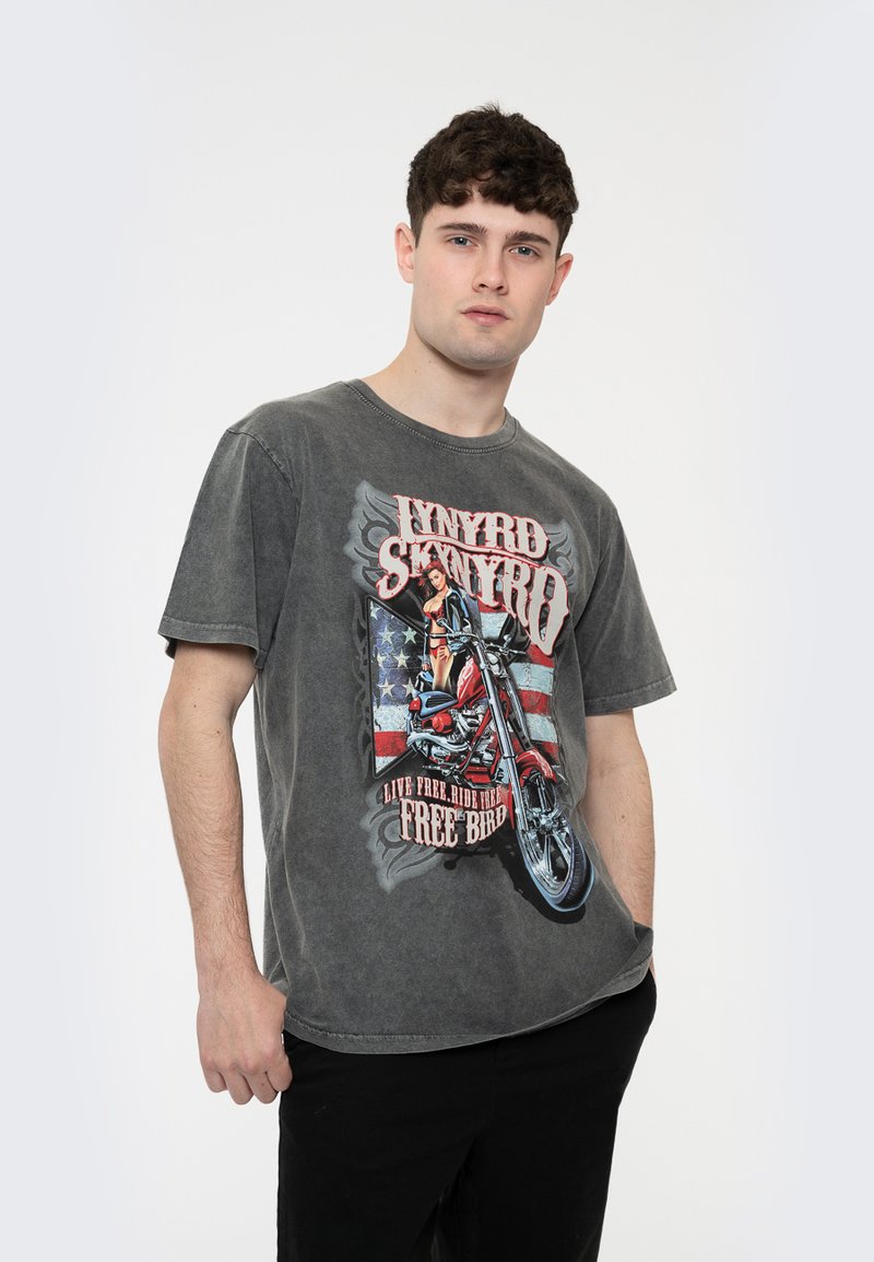 Gray cotton t-shirt with short sleeves, featuring a motorcycle graphic, stars and stripes design, and text stating "Live Free Ride Free."