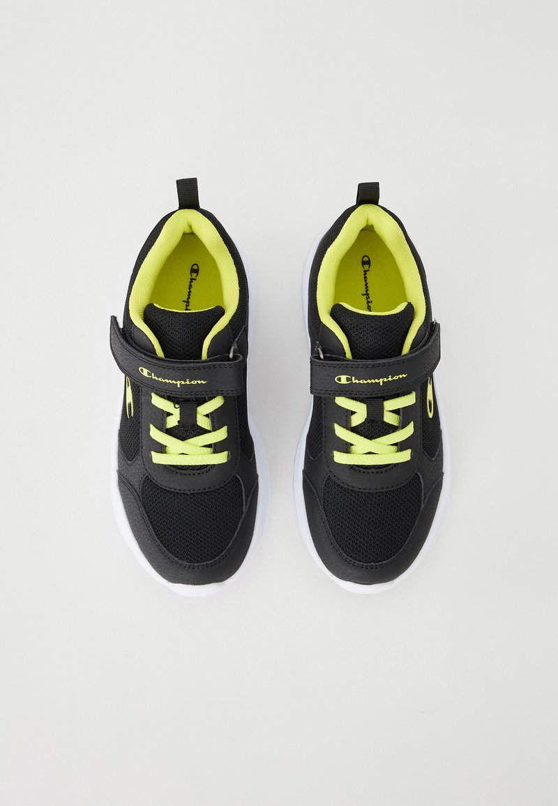 Czarne buty sportowe z żółtymi akcentami, z siateczkowego materiału, z rzepem, białą podeszwą; zawierają sznurowadła i logo z boku.