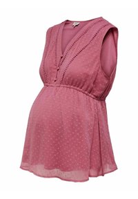 Blouse de maternité rose sans manches avec des pois texturés, col en V avec boutons en tissu et taille froncée pour une coupe ample.