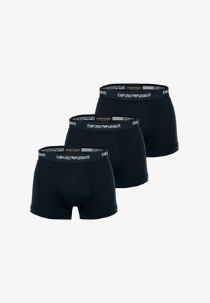 Three black Emporio Armani boxer briefs with branded elastic waistbands stacked diagonally against a white background.