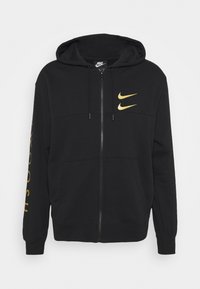 Svart zip-up hoodie i bomullsblandning med gyllene Nike-logotyper på fram- och ärmsidan, med en kenguruficka och justerbar huva.