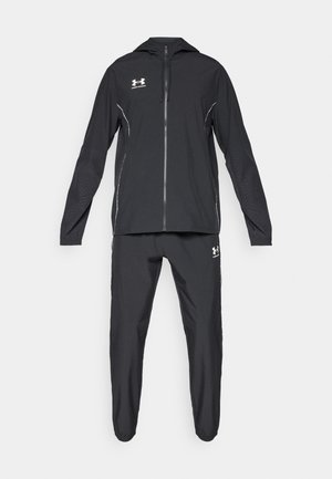 Black athletic tracksuit made of lightweight fabric; features a zip-up hoodie with a hood and tapered pants; includes white logo accents.