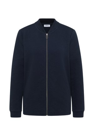 Námořnická bunda na zip s texturovaným povrchem, stojacím límcem a dlouhými rukávy. Má přední zip a minimalistický design.