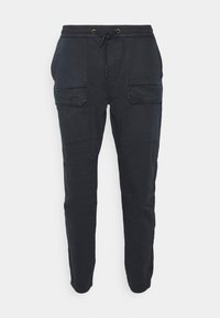 Tummansinisiä puuvillaisia cargo-housuja, joissa on kuminauhavyötärö nyörillä, kaksi etutaskua ja kapeat lahkeet.