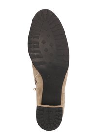 Bottines en daim beige avec une semelle en caoutchouc brun texturé. Elles sont dotées d'une fermeture éclair et d'un design légèrement courbé sur le côté.