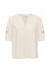 Blouse crème clair avec un col en V, manches bouffantes courtes, six boutons à l'avant et broderies florales sur les manches. Texture froissée sur l'ensemble.