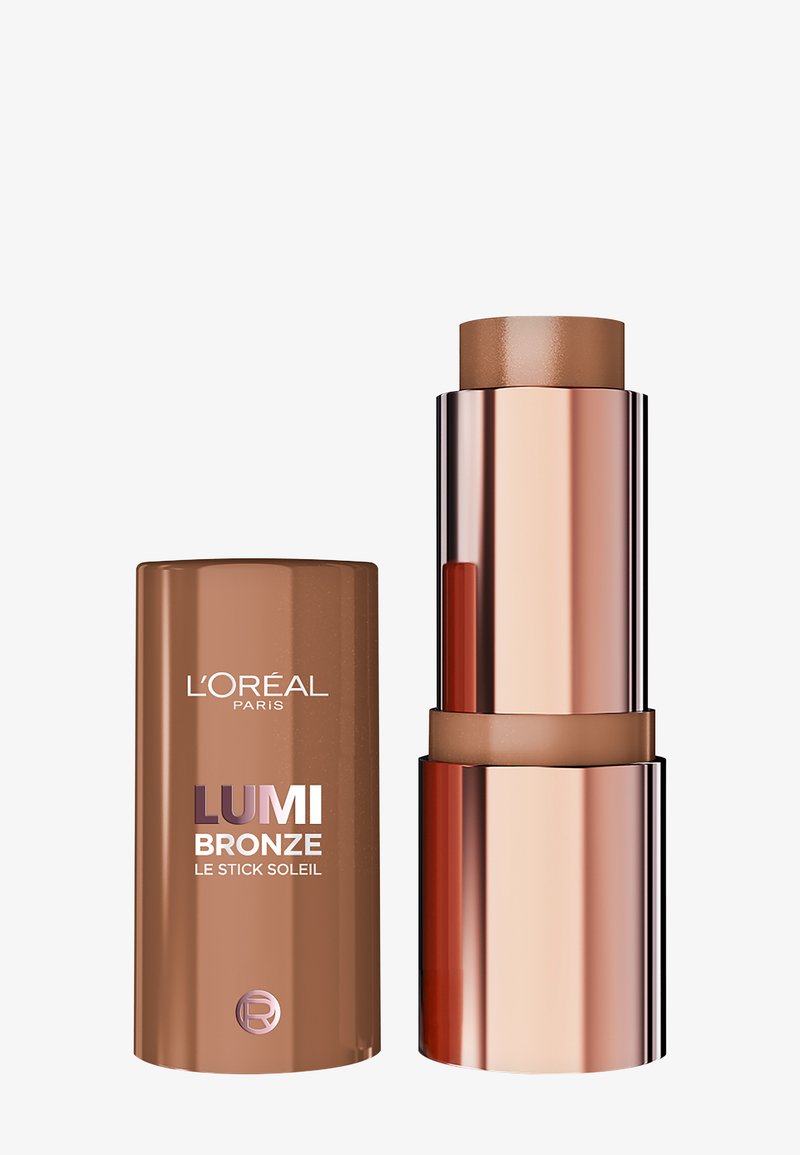 L’Oréal Lumi Bronze Bronzing-Stick mit entferntem Deckel, der bronzefarbene Make-up in elegantem roségoldenem und braunem Verpackungsdesign auf weißem Hintergrund zeigt.