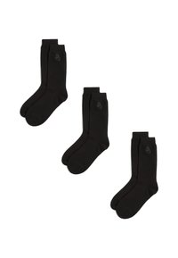 Calcetines de algodón negros tipo crew con un sutil detalle del logo. El diseño es clásico con una textura suave y puntera y talón reforzados.