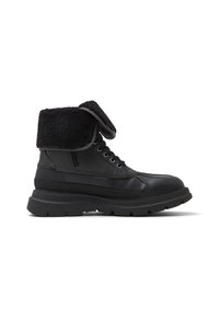 Black leather boots with a textured black fleece fold-over flap, rounded toe, and chunky rubber sole. Laces and metallic eyelets visible.