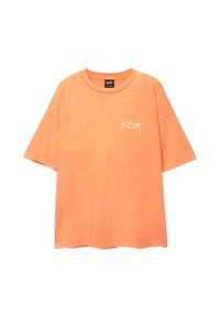 Orange bomulds T-shirt med løs pasform, korte ærmer og rund halsudskæring. Har hvidt skriftlogo på forsiden.