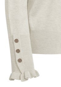 Light beige sweater with ribbed texture, featuring a textured ruffle at the sleeve hem and three decorative dark buttons along the side.