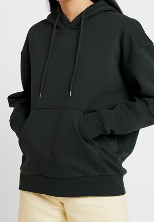 Dark green hooded sweatshirt made of soft fabric, featuring a kangaroo pocket, drawstrings, and ribbed cuffs and hem.