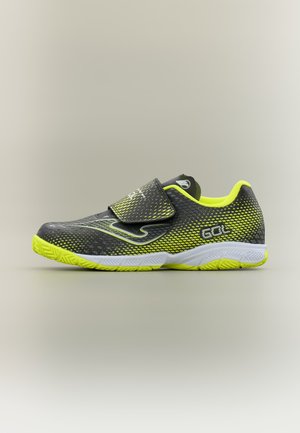 Schwarzer und neongelber Sportschuh mit Klettverschluss, gemustertem Obermaterial, weißer Sohle und "GOL" Logo an der Seite, präsentiert auf neutralem Hintergrund.